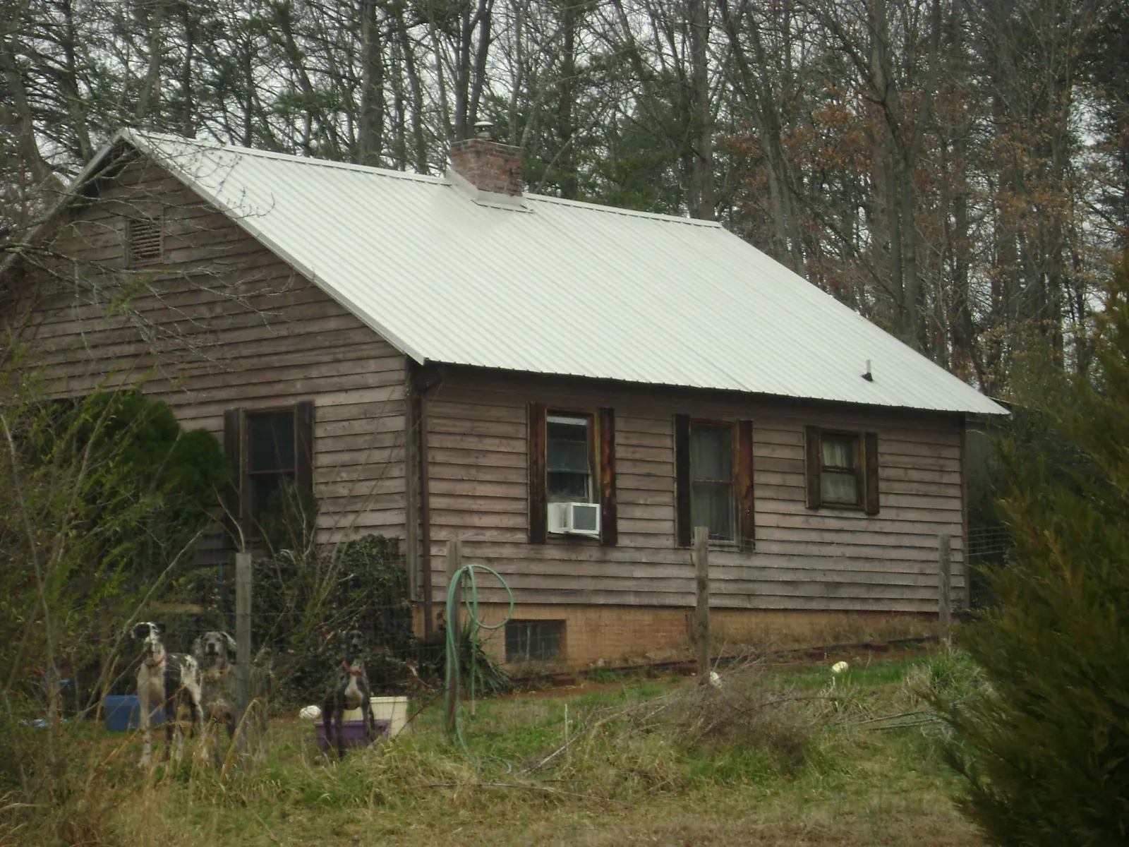 White metal roof on an old wood sided farmhouse, from a Metal Roof Installation job in Atlanta